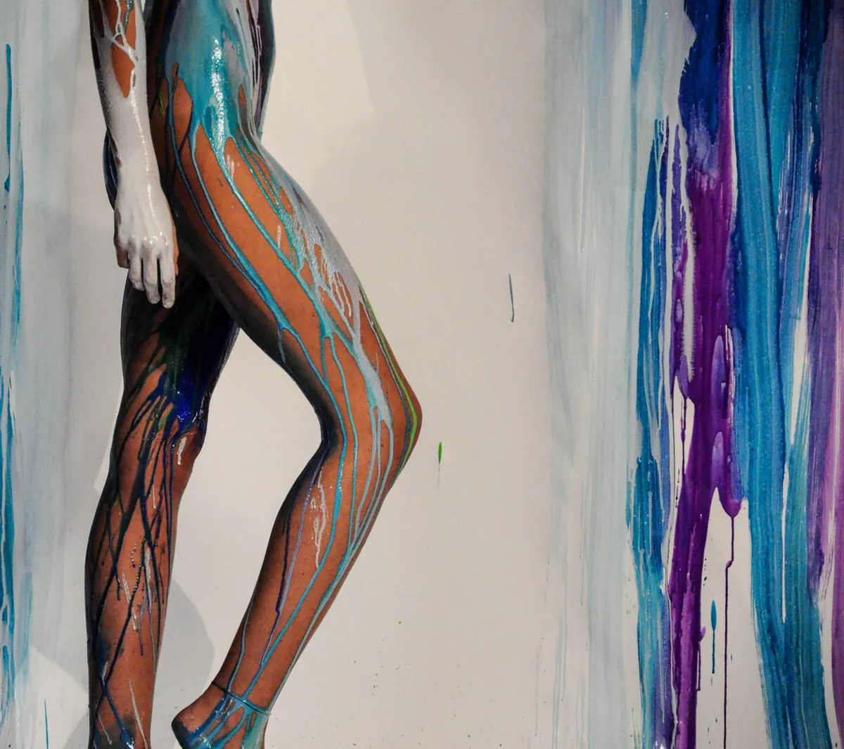 long woman legs poured by color paint