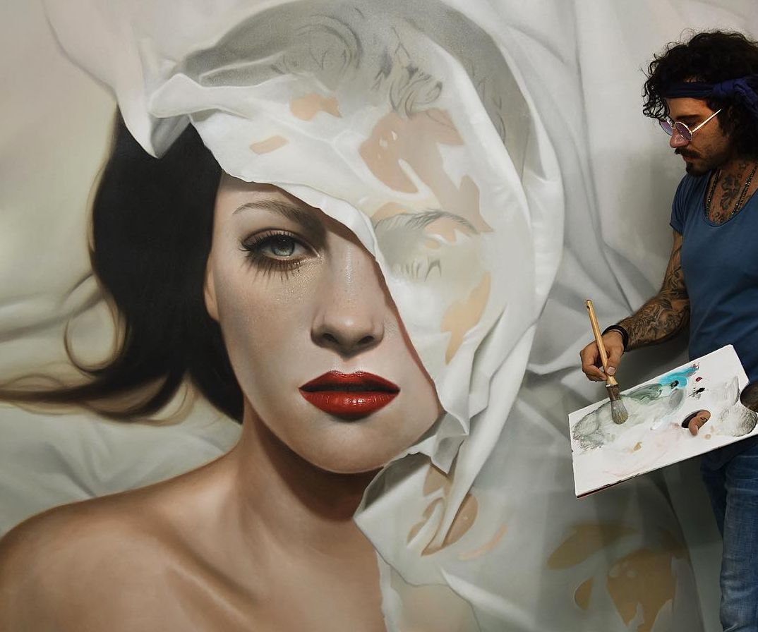 Paint made process. Artist takes paint and write a woman portrait.