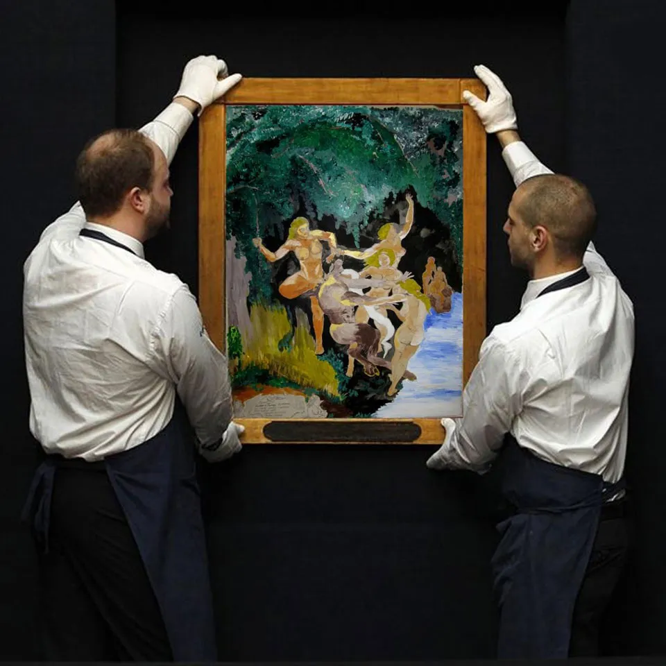 Two men showed a rare art picture before hang it. Photography in art gallery.